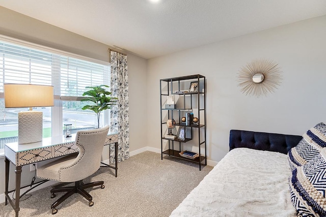 carpeted bedroom featuring baseboards