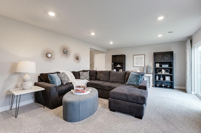 living area featuring recessed lighting, light colored carpet, and baseboards