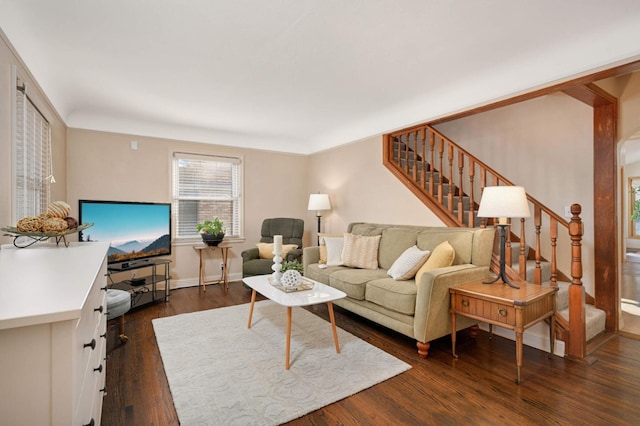 living room with stairs, baseboards, and dark wood finished floors