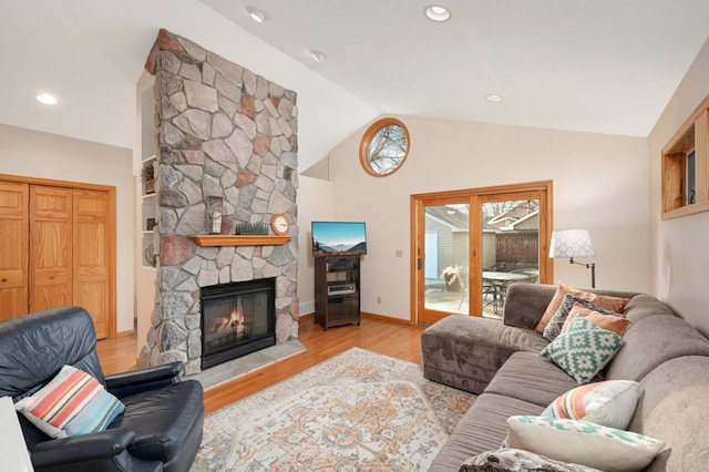 living room featuring recessed lighting, a fireplace, wood finished floors, baseboards, and vaulted ceiling