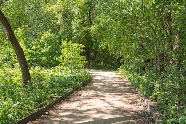 view of property's community featuring a wooded view