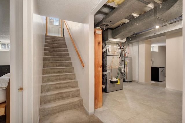 stairway with heating unit, baseboards, and gas water heater