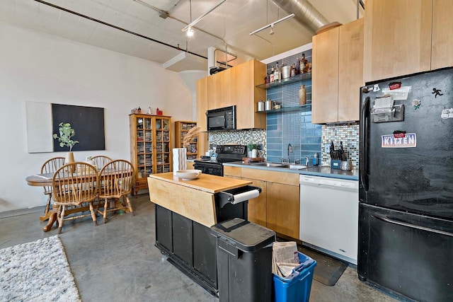 kitchen featuring black appliances, a sink, open shelves, backsplash, and concrete floors