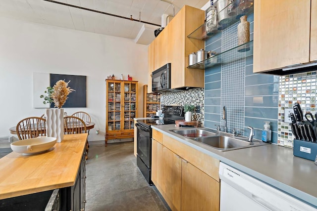 kitchen with finished concrete flooring, light brown cabinets, a sink, black appliances, and backsplash