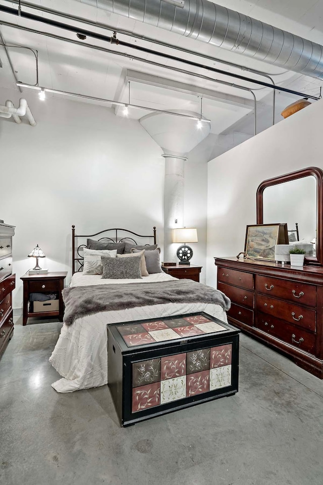 bedroom featuring finished concrete floors