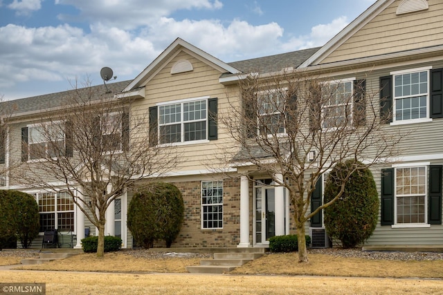 multi unit property featuring brick siding and central AC unit