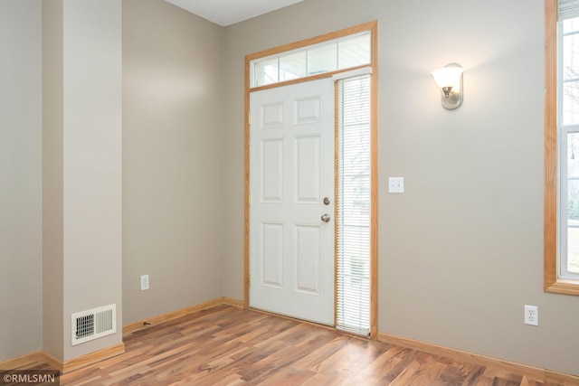 entryway with light wood-style floors, visible vents, and baseboards