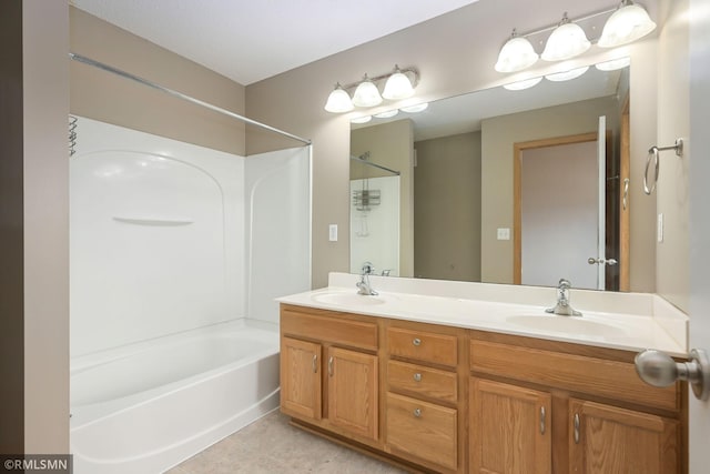 full bathroom featuring double vanity, a sink, washtub / shower combination, and tile patterned floors