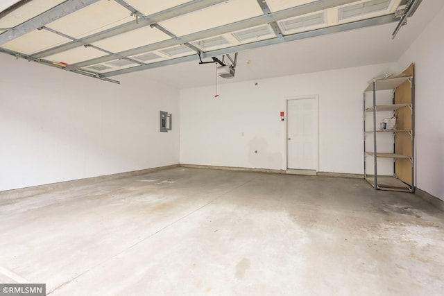 garage featuring electric panel and a garage door opener