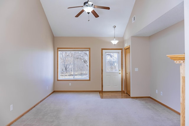 foyer featuring light carpet, visible vents, baseboards, and lofted ceiling