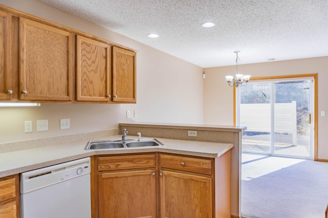 kitchen with a textured ceiling, white dishwasher, a peninsula, a sink, and light countertops