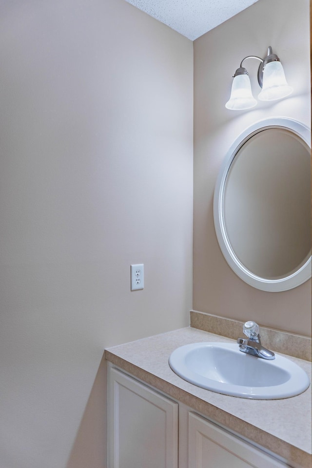 bathroom featuring a textured ceiling and vanity