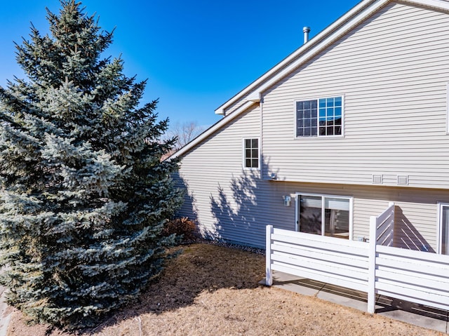 view of home's exterior with fence