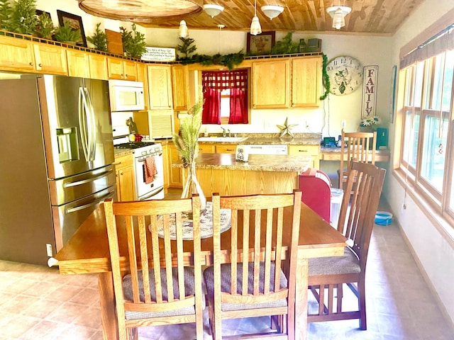 kitchen with white appliances, wood ceiling, a sink, and light brown cabinetry