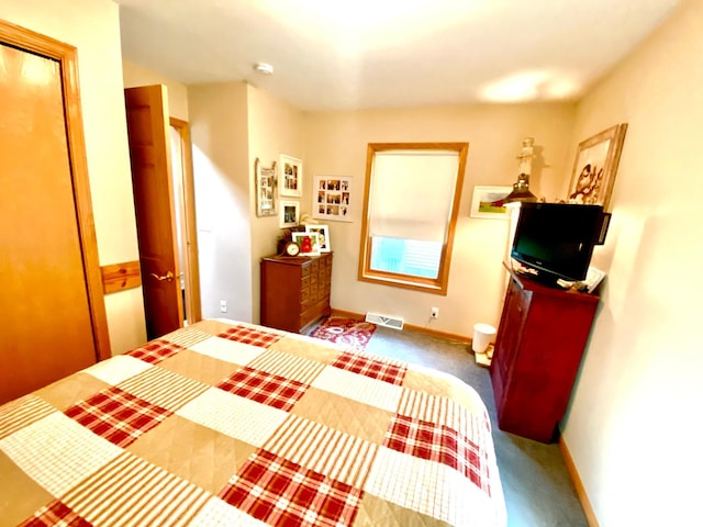 carpeted bedroom with visible vents and baseboards