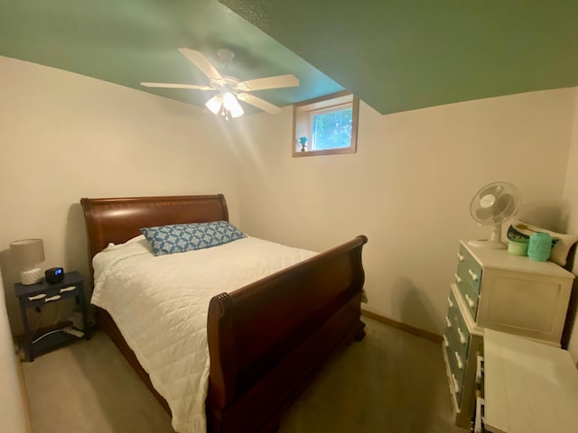 carpeted bedroom with ceiling fan and baseboards