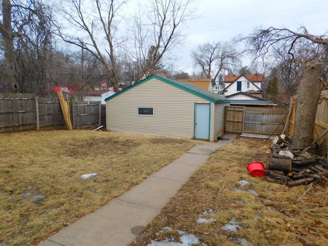 view of outbuilding with a fenced backyard and an outdoor structure