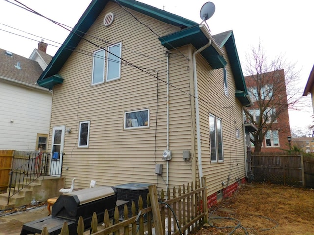 rear view of property with fence