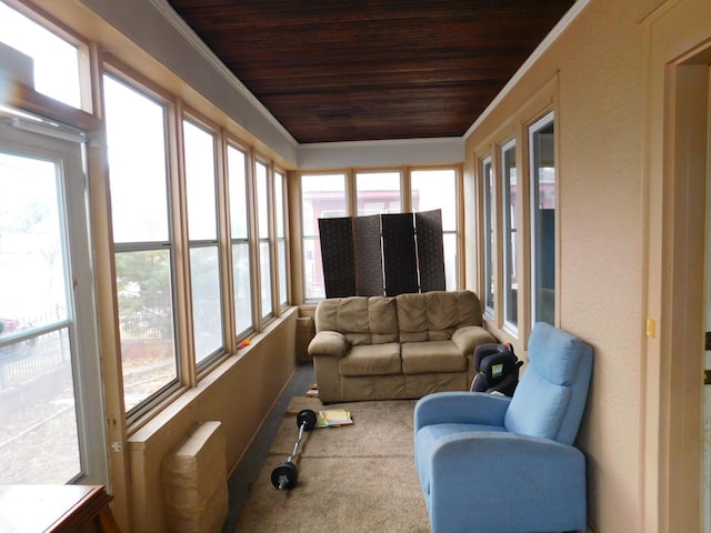 sunroom with wood ceiling and a healthy amount of sunlight