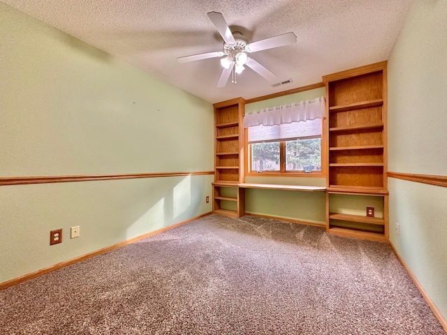 interior space featuring visible vents, baseboards, ceiling fan, carpet, and a textured ceiling