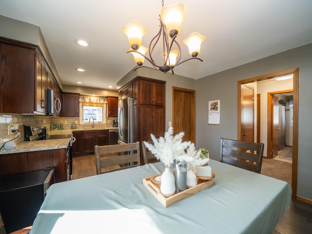 dining area with a notable chandelier and recessed lighting