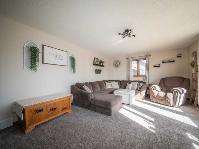 living room featuring visible vents, a textured ceiling, and carpet floors