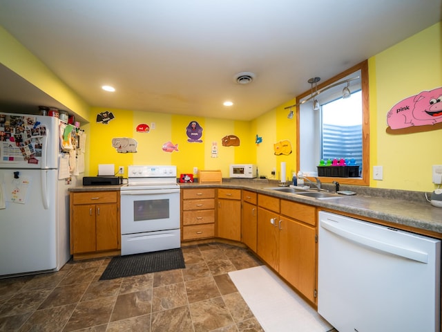 kitchen with white appliances, recessed lighting, visible vents, and a sink