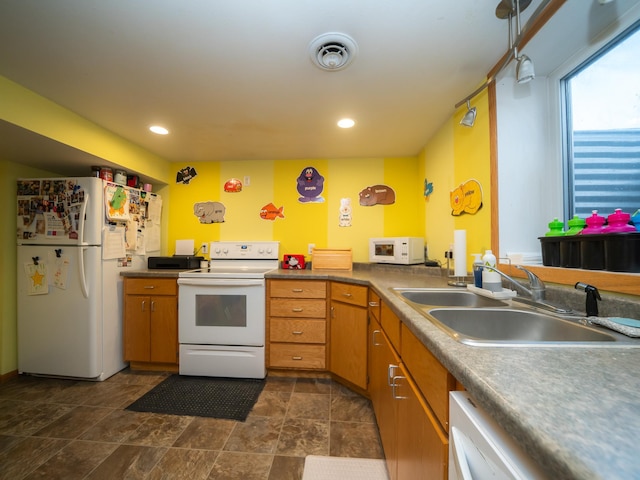 kitchen with white appliances, visible vents, recessed lighting, a sink, and brown cabinets