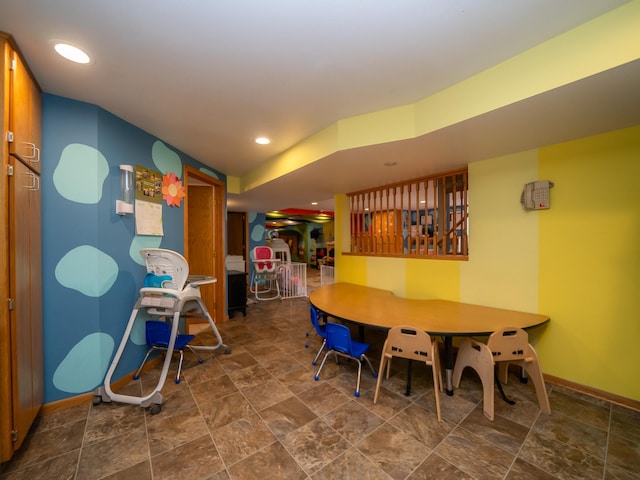 dining room with stone finish floor, recessed lighting, and baseboards