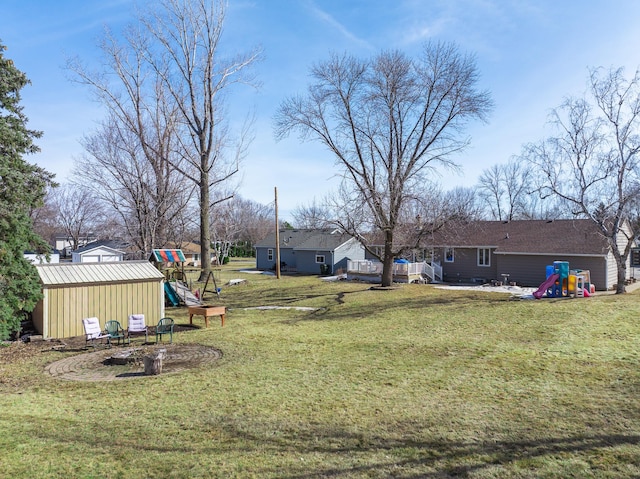 view of yard featuring an outbuilding and a playground