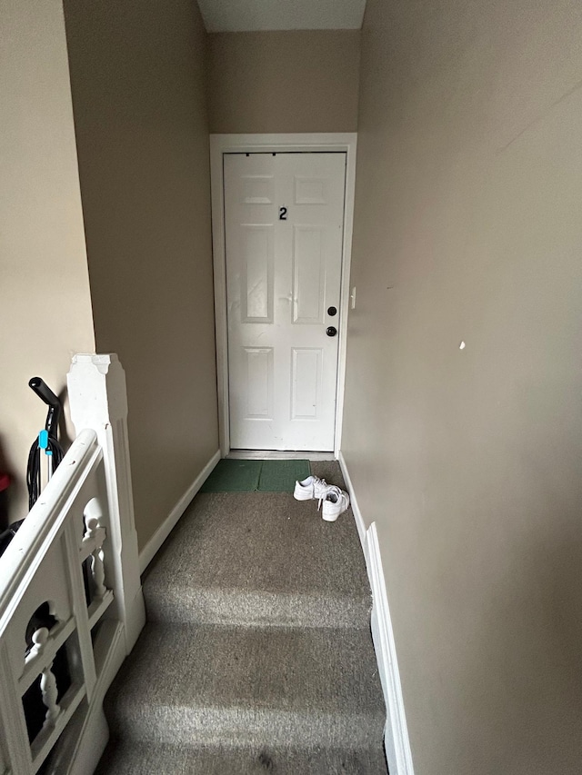 stairs featuring carpet floors and baseboards