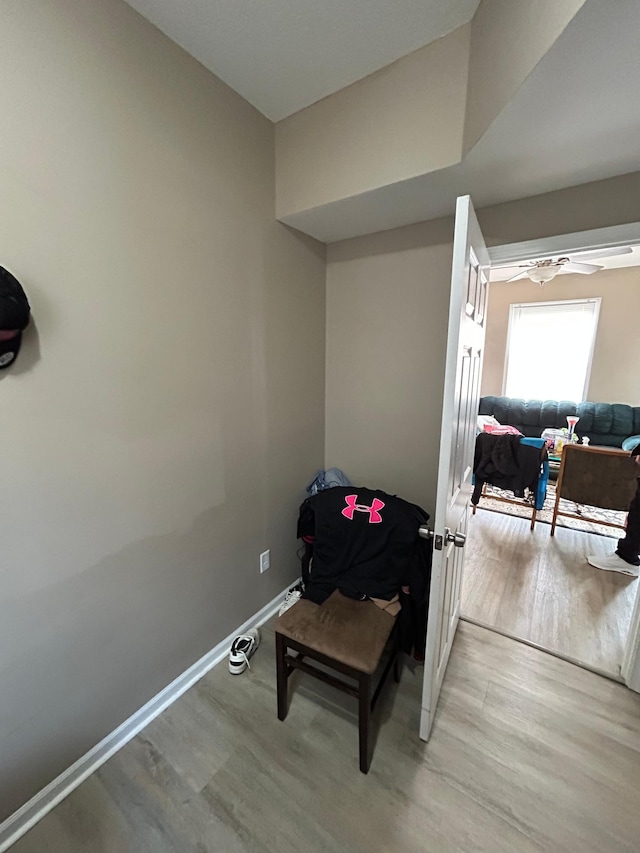 sitting room featuring light wood-style floors, ceiling fan, and baseboards