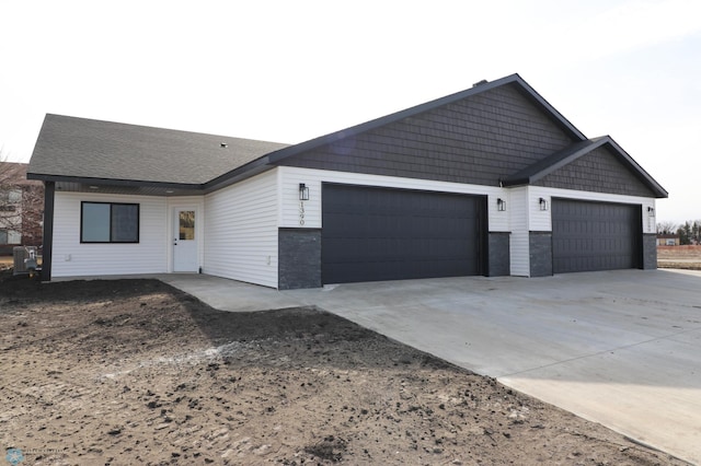 ranch-style house featuring an attached garage and driveway