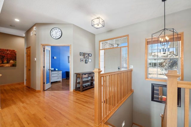 entrance foyer featuring recessed lighting, light wood-type flooring, baseboards, and an inviting chandelier