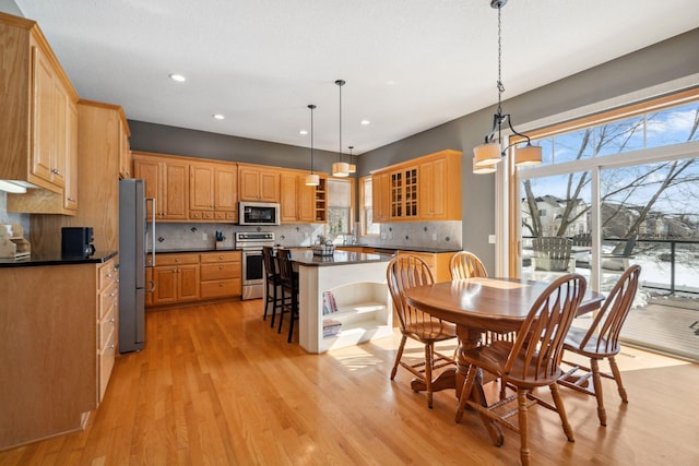 dining space featuring light wood-style flooring and recessed lighting