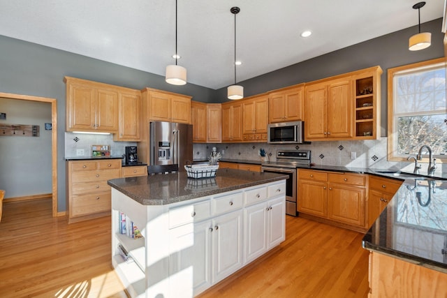 kitchen with open shelves, stainless steel appliances, light wood-type flooring, and a sink