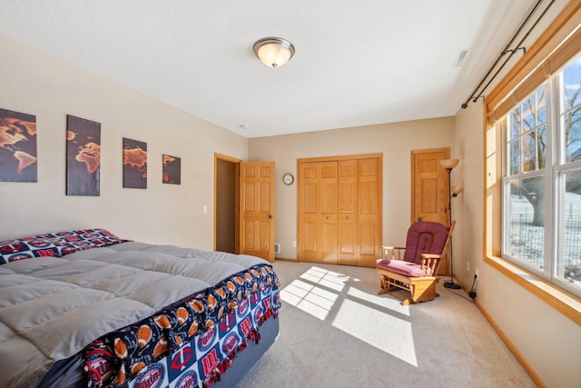 bedroom with carpet flooring, multiple windows, and baseboards