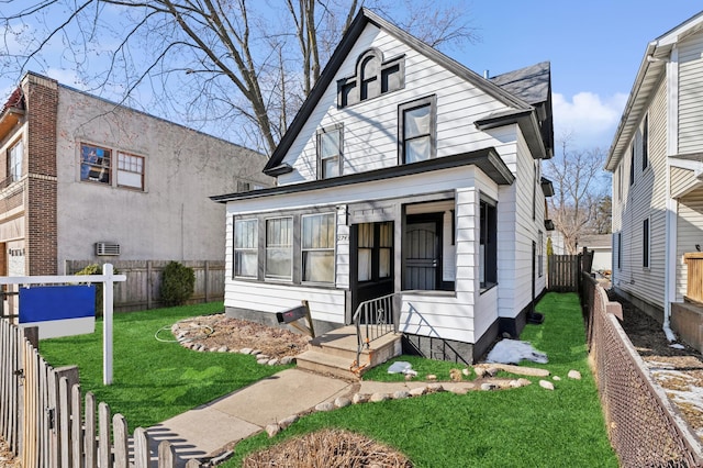 view of front facade with a front lawn and a fenced backyard