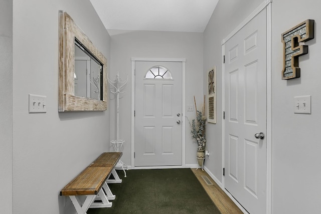 interior space with wood finished floors, visible vents, and baseboards