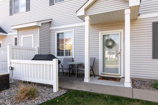 property entrance with central air condition unit and fence