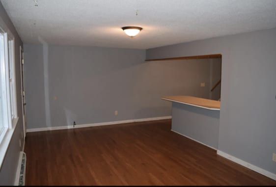 spare room with wood finished floors and baseboards