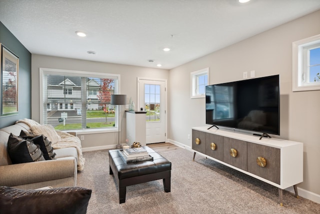 living room featuring carpet floors, baseboards, and recessed lighting