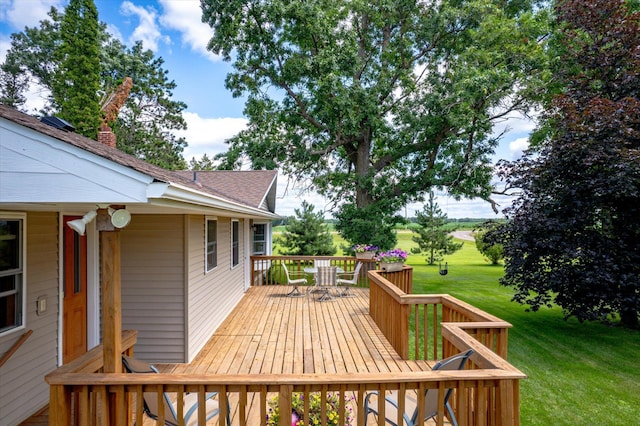 wooden terrace with a lawn