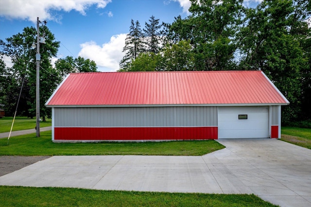 view of property exterior featuring a garage, a yard, metal roof, and an outdoor structure