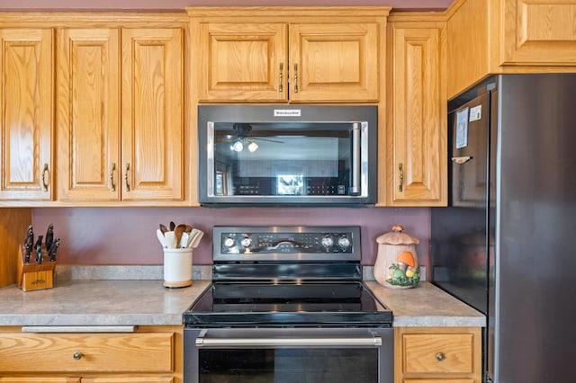 kitchen featuring light countertops and appliances with stainless steel finishes