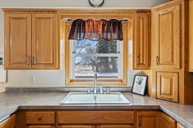 kitchen with brown cabinets and a sink