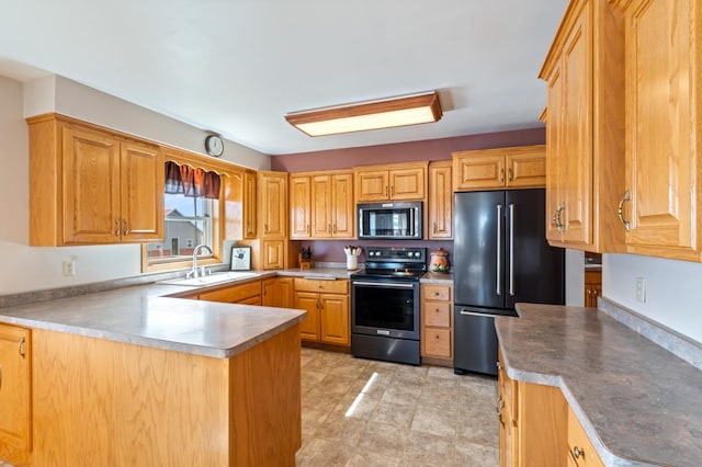 kitchen with a sink, a peninsula, stainless steel electric range, and high end refrigerator