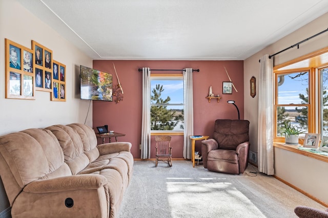 carpeted living room featuring plenty of natural light and baseboards