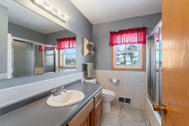 full bathroom featuring plenty of natural light, tile patterned flooring, visible vents, and vanity