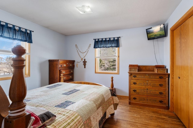 bedroom featuring a textured ceiling and wood finished floors